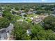 An high angle aerial view of the home and its surroundings, including mature trees and other homes at 3518 Edlingham Ct, Belle Isle, FL 32812