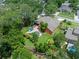 Aerial view of the backyard with a luxurious pool, landscaping and cozy lounge area at 3518 Edlingham Ct, Belle Isle, FL 32812