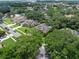 Aerial view of the home in a lush, mature neighborhood offering the privacy of mature trees at 3518 Edlingham Ct, Belle Isle, FL 32812