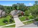Aerial view of the home with its well-maintained lawn and mature trees at 3518 Edlingham Ct, Belle Isle, FL 32812