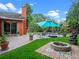 Inviting backyard featuring a pool, lounge chairs, lush landscaping, and cozy firepit area at 3518 Edlingham Ct, Belle Isle, FL 32812