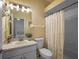 Bathroom with a shower/tub combo, white cabinet and mirror at 3518 Edlingham Ct, Belle Isle, FL 32812