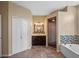 Bathroom featuring a walk-in shower, soaking tub, and vanity with stylish lighting at 3518 Edlingham Ct, Belle Isle, FL 32812