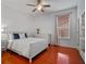 Bedroom with wooden floors, white walls, and a window providing natural light at 3518 Edlingham Ct, Belle Isle, FL 32812