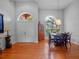 Formal dining area with hardwood floors, arched windows, and stylish decor at 3518 Edlingham Ct, Belle Isle, FL 32812