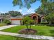 Charming orange home with a well manicured lawn and mature landscaping at 3518 Edlingham Ct, Belle Isle, FL 32812