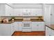 Well-lit kitchen with white cabinetry, stainless steel appliances, and stylish backsplash at 3518 Edlingham Ct, Belle Isle, FL 32812