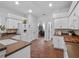 Bright kitchen with white cabinets, tiled floors, and contrasting countertops, perfect for cooking at 3518 Edlingham Ct, Belle Isle, FL 32812