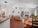 Open-concept living room with fireplace, hardwood floors, and natural light at 3518 Edlingham Ct, Belle Isle, FL 32812