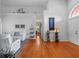 Open living room with hardwood floors and vaulted ceilings, showcasing stylish decor at 3518 Edlingham Ct, Belle Isle, FL 32812