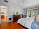 Bedroom featuring hardwood floors, neutral walls, and patio access at 3518 Edlingham Ct, Belle Isle, FL 32812