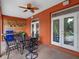 Back patio with outdoor dining table, ceiling fan and wood accent wall at 3518 Edlingham Ct, Belle Isle, FL 32812