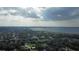 Aerial view of a residential area near a lake and coastline featuring lush greenery at 455 Orange Ave, St Cloud, FL 34769
