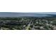 Aerial view showcasing neighborhood homes, a lake, and lots of mature tree coverage at 455 Orange Ave, St Cloud, FL 34769