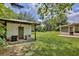 Lush backyard featuring an additional structure, screened porch, and ample green space at 455 Orange Ave, St Cloud, FL 34769