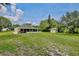 Wide view of a large backyard with a screened porch and additional structure at 455 Orange Ave, St Cloud, FL 34769