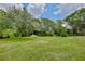 Spacious green backyard with mature trees, offering privacy and natural beauty at 455 Orange Ave, St Cloud, FL 34769