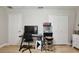 Basement area with gray walls, laminate floors, game console, and white closet doors at 455 Orange Ave, St Cloud, FL 34769