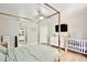 Bright bedroom with a four-poster bed, ceiling fan, and ensuite bathroom at 455 Orange Ave, St Cloud, FL 34769