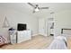 Spacious bedroom with ceiling fan, direct access to a modern ensuite bathroom at 455 Orange Ave, St Cloud, FL 34769