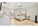 Light and airy bedroom with four-poster bed, ceiling fan, and bright natural light at 455 Orange Ave, St Cloud, FL 34769