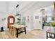 Bright dining room with wood table, stylish lighting, and views of the kitchen at 455 Orange Ave, St Cloud, FL 34769