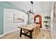 Dining area featuring a large wooden table, modern light fixture and stylish decor at 455 Orange Ave, St Cloud, FL 34769