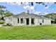 Welcoming single-story home with lush lawn, black-framed windows, and a charming front porch at 455 Orange Ave, St Cloud, FL 34769