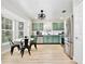 Modern kitchen with stainless steel appliances, green cabinets, and a cozy breakfast nook at 455 Orange Ave, St Cloud, FL 34769
