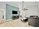 Cozy living room with modern decor, vaulted ceiling, and a sleek entertainment center at 455 Orange Ave, St Cloud, FL 34769