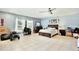 Spacious main bedroom with light blue walls, tile floors, ceiling fan, and dark wood furniture at 455 Orange Ave, St Cloud, FL 34769