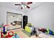 Playroom area with toys and play equipment, opens to adjoining living room with gray couch at 455 Orange Ave, St Cloud, FL 34769