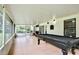 Spacious screened porch featuring tile flooring and a billiard table for entertainment at 455 Orange Ave, St Cloud, FL 34769