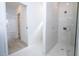 Hallway view of full bathroom featuring shower and glass door at 506 St Johns Ct, Poinciana, FL 34759