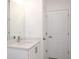 Clean bathroom featuring a modern white vanity with a granite countertop at 506 St Johns Ct, Poinciana, FL 34759
