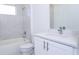 Clean bathroom with white tile, a shower/tub combo, and a white vanity with silver fixtures at 506 St Johns Ct, Poinciana, FL 34759