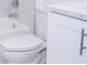 Modern bathroom featuring a white toilet, marble wall, and countertop at 506 St Johns Ct, Poinciana, FL 34759
