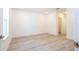 Bright bedroom with modern wood-look flooring, light walls, and natural light from window at 506 St Johns Ct, Poinciana, FL 34759