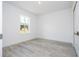Bedroom with a window and a closet with light gray wood-look flooring at 506 St Johns Ct, Poinciana, FL 34759
