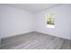 Bright, spacious bedroom with light wood floors and a view to the backyard at 506 St Johns Ct, Poinciana, FL 34759