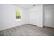 Light-filled bedroom with wood-style flooring and double door closet at 506 St Johns Ct, Poinciana, FL 34759