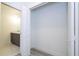 Open closet view with bathroom featuring vanity and lighting at 506 St Johns Ct, Poinciana, FL 34759