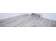 Close-up of light gray wood-look flooring with white baseboard trim at 506 St Johns Ct, Poinciana, FL 34759