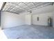 Spacious garage with concrete floor, overhead door, and ample storage space at 506 St Johns Ct, Poinciana, FL 34759