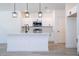 A well-lit kitchen with white cabinets, quartz countertops, and stainless steel appliances at 506 St Johns Ct, Poinciana, FL 34759
