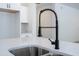 Close-up of kitchen sink with black faucet and quartz countertop at 506 St Johns Ct, Poinciana, FL 34759
