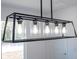 Modern light fixture with multiple exposed bulbs in a rectangular frame at 506 St Johns Ct, Poinciana, FL 34759