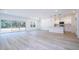 Open-concept living space featuring ample natural light, vinyl plank floors, and a modern kitchen at 506 St Johns Ct, Poinciana, FL 34759