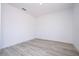 Bright, open room with light gray wood-look flooring, baseboard trim, and neutral paint throughout at 506 St Johns Ct, Poinciana, FL 34759