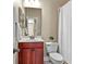 Well-lit bathroom with a single sink, toilet and shower with a decorative curtain at 5303 Brady Ln, Orlando, FL 32814